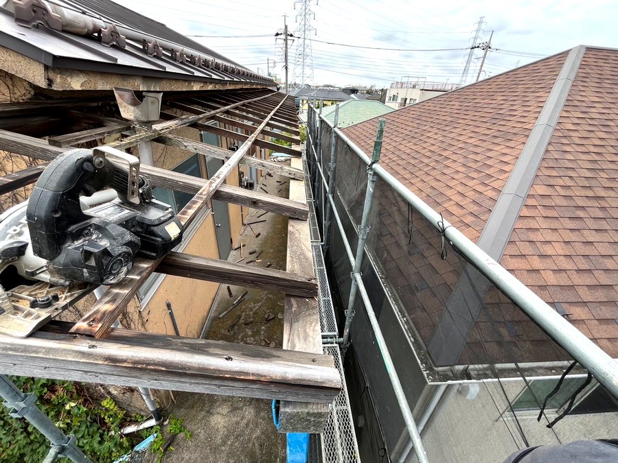 傷んだ軒先の下地木部を丸ノコで加工しているようす
